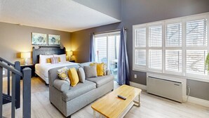 A modern hotel room with a bed, sofa, and a small table. - The Adventure Pad: Pool, Hot Tub, Tennis! (The Blue Mountains)