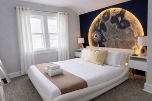 A hotel room with a large bed, white curtains, a moon-themed wall mural, and bedside lamps. - 2 Stylish Units +Game Room Near Airport & Downtown (Milwaukee)
