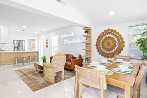 A modern living space with a kitchen, dining area, and a neon sign. - Beautiful 3-bedroom house with AC in Fort Lauderdale near Beach,Downtown,Airport (Fort Lauderdale)