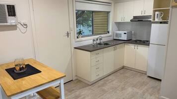 Microwave, cookware/dishes/utensils, dining tables