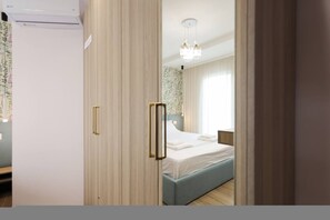 A bedroom with a bed, a bedside table, a nightstand, a chandelier, and a window with curtains. - Cozy Apartment 02 in Durr s (Durrës)