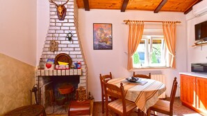 Un interno rustico con un camino, mobili in legno e una finestra con tende.