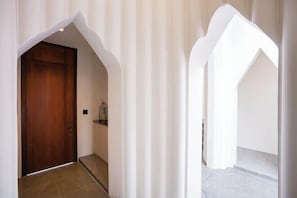 A hallway with a wooden door, white curtains, and a tiled floor. - Moon 5-Bedroom Luxury Pool Villa (Pattaya)