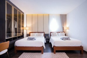 A hotel room with two beds, a large mirror, a wardrobe, and a window with curtains. - Moon 5-Bedroom Luxury Pool Villa (Pattaya)