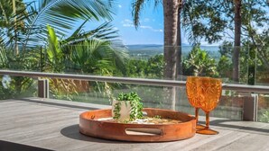 A balcony with a wooden table, a copper tray with a plant, and a glass. - Resort Unit, Heated Pool, AC, Walk to Main Beach (Noosa Region)