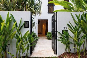 A gated entrance with a pathway leading to a building, surrounded by lush greenery. - Spacious & Stylish Family Oasis on Noosa Hill (Noosa Region)