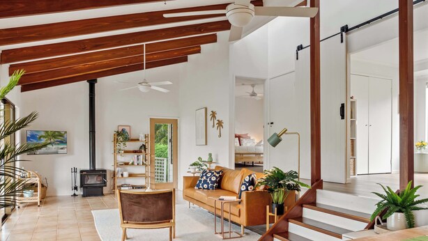 A spacious living area with a sofa, coffee table, and a fireplace.