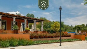 A building with a covered patio area, outdoor seating, and potted plants. - Beautiful House in San Miguel de Allende - Private (San Miguel de Allende)