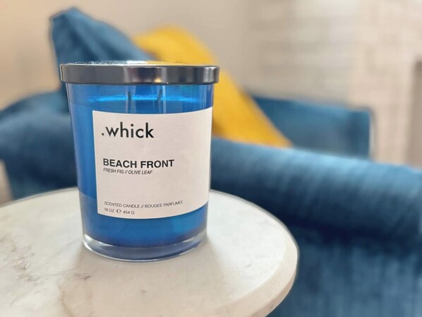 A blue scented candle labeled 'Beach Front' on a white table. - This apartment is a 2 bedroom(s), 1 bathrooms, located in Erie, PA. (Erie)
