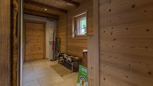 A wooden interior with a bed, a coat rack, and a window. - La Seille - HAUTELUCE (HAUTELUCE)