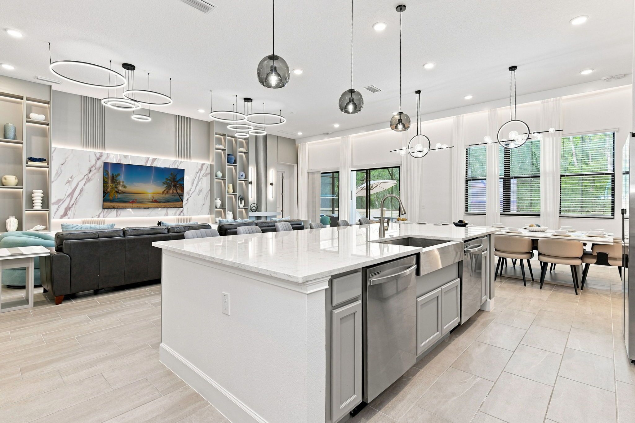 A modern kitchen with a central island, stainless steel appliances, and pendant lighting.
