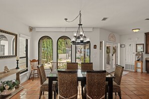 A dining area with a table, chairs, and a chandelier. - Private Boat Dock & Hot Tub | Waterfront Villa! (Destin)