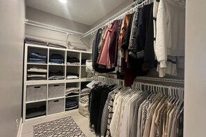 A walk-in closet with shelves, drawers, and hanging space for clothes. - Luxury Executive Retreat | Gym & Dual Office (Crystal Lake)