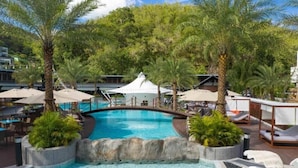 A pool area with lounge chairs, palm trees, and a white gazebo. - 60sqm Pool Access Suite in Patong w/ Views C81 (Pataong)