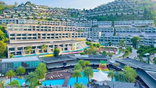 A hotel with multiple buildings, a swimming pool, and a hilly backdrop. - 60sqm Pool Access Suite in Patong w/ Views C81 (Pataong)