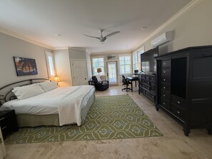 A bedroom with a bed, a desk, a chair, a dresser, and a ceiling fan. - Endless Summer House , Lagoon Pool, Private Beach, Bikes (Inlet Beach)