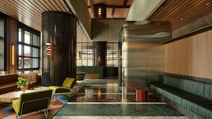 A spacious lobby with seating areas, a reception desk, and large windows. - Southbank Level 51 Panoramic Views w/ Pool & Sauna (Southbank)