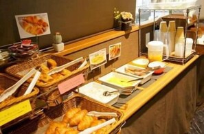 A buffet setup with various food items and utensils. - Hotel Livemax Yokohama Station West Exit (Yokohama)