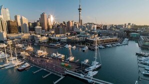 A marina with boats docked, a prominent tower, and a dense urban skyline. - Stylish New York Loft in the Heart of Parnell (Parnell)