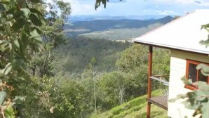 Una casa con un balcone affacciata su un paesaggio collinare.