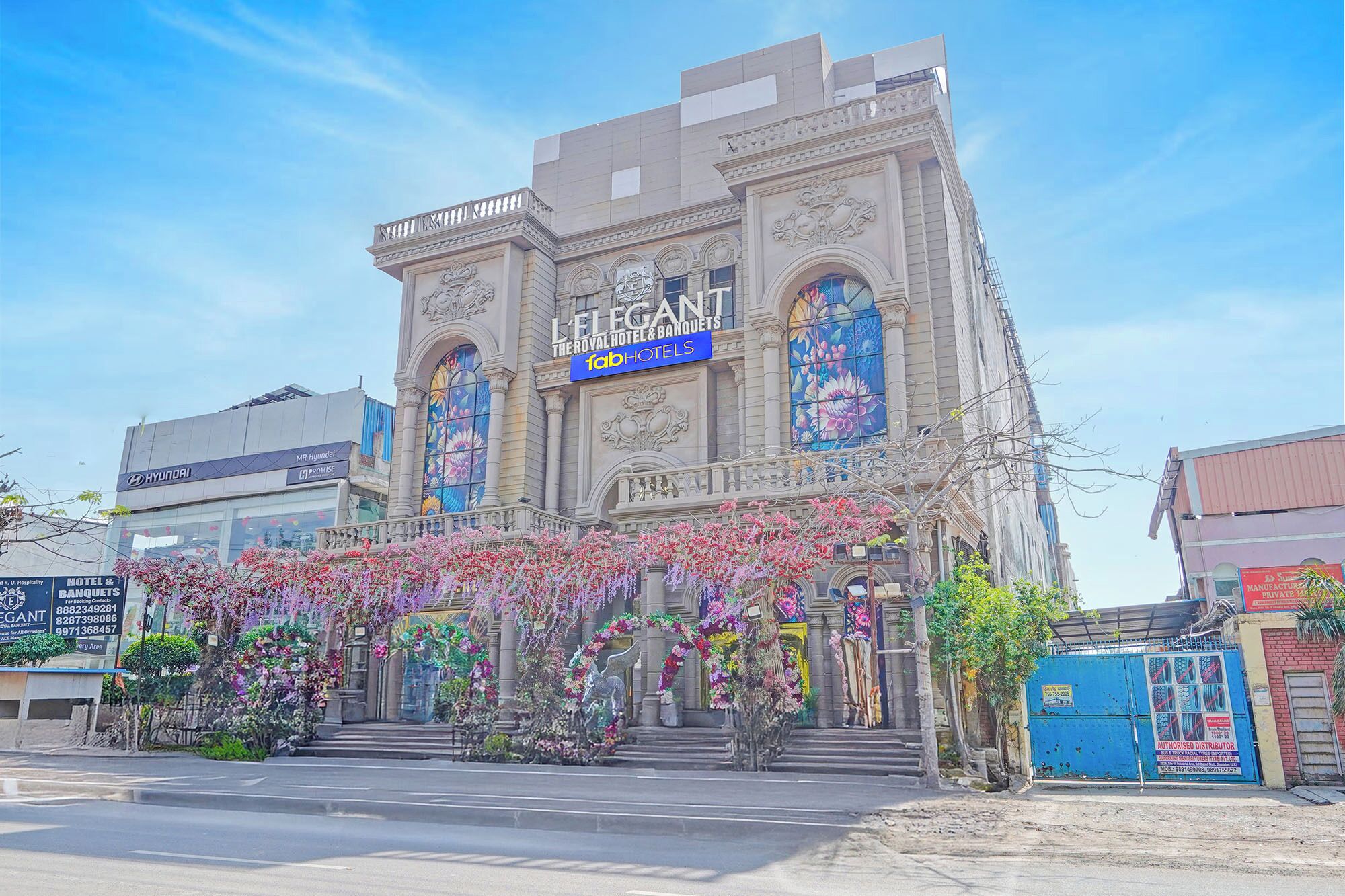 A hotel with a classical facade, a large entrance, and a sign for 'Le Imperial Hotel & Banquets.'