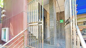A gated entrance with a metal staircase leading to a building entrance. - FabHotel Exotic Stay - Kalyan Nagar (Bangalore)