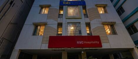 A building with a sign for 'fab hotels' and 'RVC Hospitality' indicating it is a hotel.