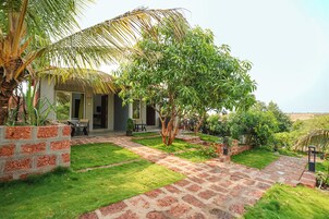 Una casa con patio, un jardín pequeño y vistas al campo.