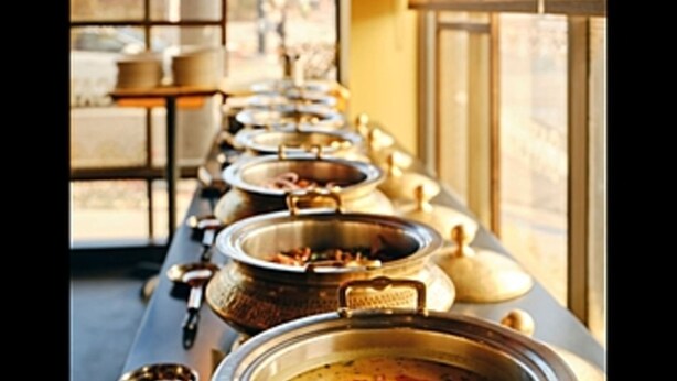 A buffet line with multiple food containers.