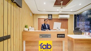 A reception desk with a sign indicating 'Right of Admission Reserved' and 'Reception' at a hotel.