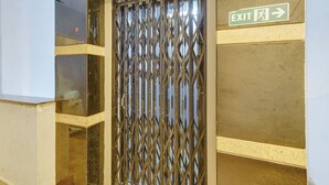 A metallic security gate with an EXIT sign above it.