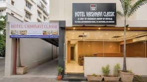 The exterior of Hotel Vaishnavi Classic, including its signage and entrance.