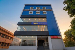 A modern building with a sign for 'Saanidhya Comforts' and 'fabHOTELS'. - FabHotel Saanidhya Comforts - Tumkur Road (Kunigal)