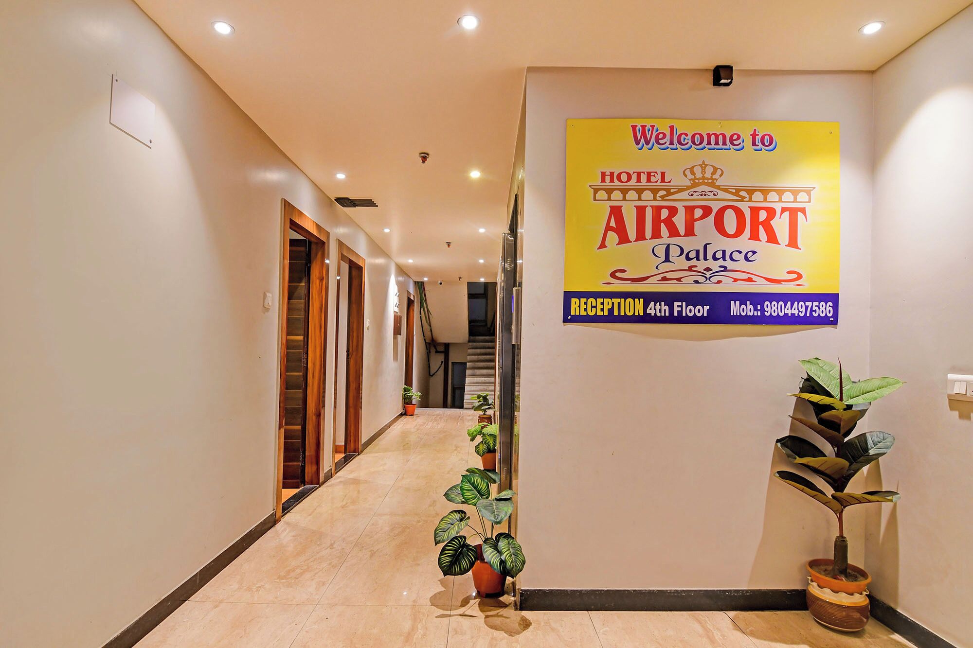 A hotel reception area with a sign indicating it's the Airport Palace, located on the 4th floor.