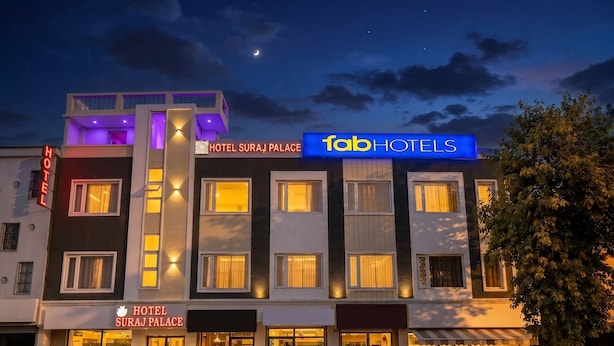 Hotel Suraj Palace with a modern facade, illuminated signage, and a visible entrance. - FabHotel Suraj Palace (Indore)