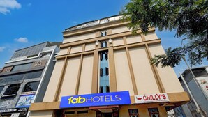 A building with a sign for 'fabHOTELS' and 'CHILLY'S' restaurant.