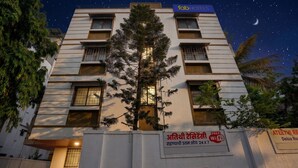 A multi-story building with a sign indicating free WiFi and 24x7 availability. - Fabhotel Ateethi Residency (Pune)