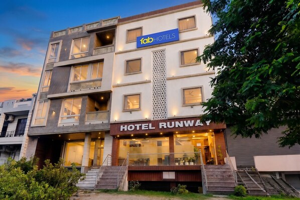A multi-story hotel with a sign for 'HOTEL RUNWAY' and a 'fabHOTELS' logo. - FabHotel Runway - Patrika Gate (Jaipur)