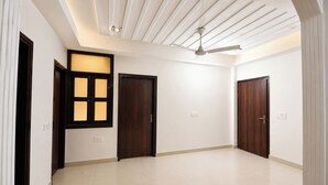 A spacious room with a high ceiling, recessed lighting, and a ceiling fan. - Via Chahal (New Delhi)