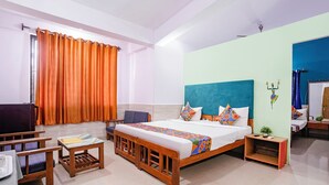 Una habitación de hotel con una cama grande, un escritorio, una silla y una mesita.