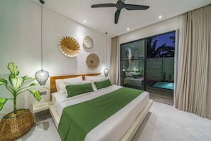 Ein modernes Schlafzimmer mit Bett, Deckenventilator, Wanddekoration, einer Topfpflanze und Blick auf einen Pool.