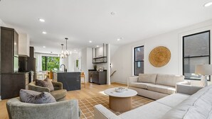 A modern living room with a sofa, armchairs, and a coffee table. - Iconic retreat w/ exclusive rooftop lounge & spa! (Nashville)