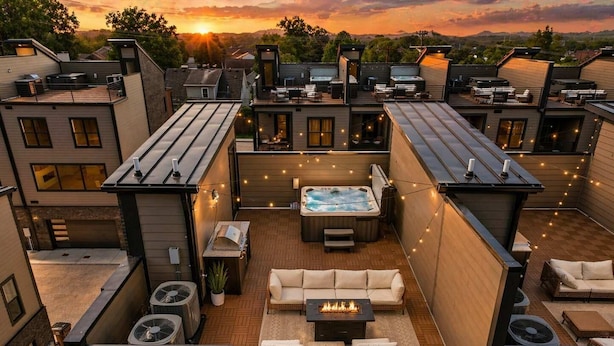 A rooftop patio with a hot tub, outdoor seating, and string lights. - Iconic retreat w/ exclusive rooftop lounge & spa! (Nashville)