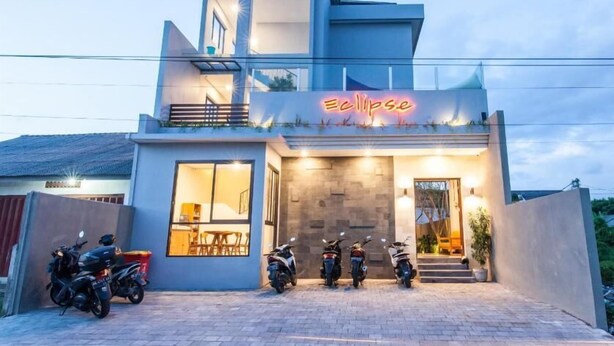 A modern building with a neon sign reading 'Eclipse.' - Eclipse Kerobokan (Seminyak)
