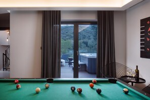 A pool table with balls, a hot tub, and a view of a forest through large windows. - Villa Valmata Adriatic Pearl /w Pool & Wellness (Rasa)