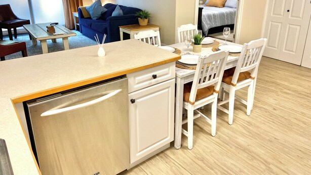 A compact living space with a kitchenette, dining area, and a bedroom. - Spacious 2 BR Suite, Family Friendly, near Colwood Waterfront, Royal Roads Univ (Victoria)
