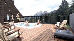 A wooden deck with a hot tub, lounge chairs, and a view of mountains. - RETRORIDGE - DOWNTOWN - ROOFTOP HOT TUB (Canmore)