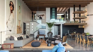 A modern living room with a sofa, coffee table, and decorative items. - Villa Sierra (Koh Samui)