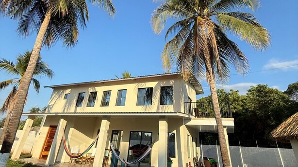 A two-story house with a balcony, surrounded by palm trees. - Just 5-minutes away to the beach. Spacious 5-bedroom house at Costa Azul,Metalio (Metalio)