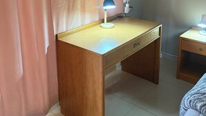 A room with a wooden desk, a lamp, a nightstand, and a bed. - Perfect 3 x 1-bedroom Rooms in beautiful Sasolburg for your getaway (Sasolburg)